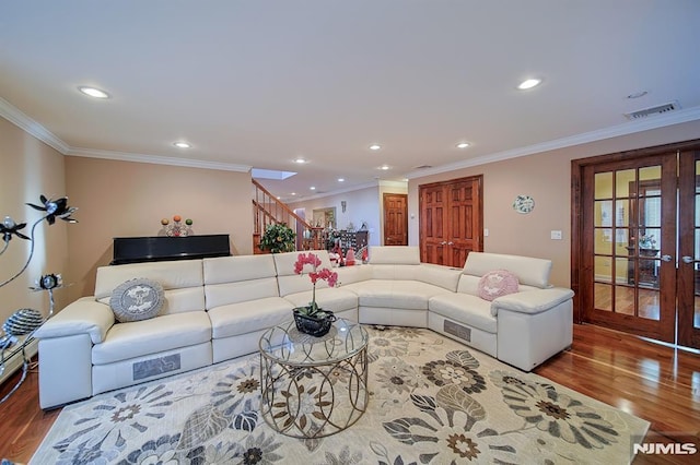 living room with hardwood / wood-style flooring and crown molding