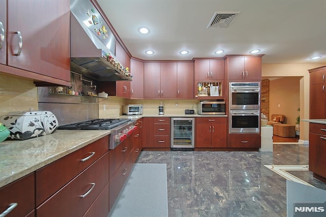 kitchen with decorative backsplash, appliances with stainless steel finishes, light stone countertops, beverage cooler, and wall chimney range hood