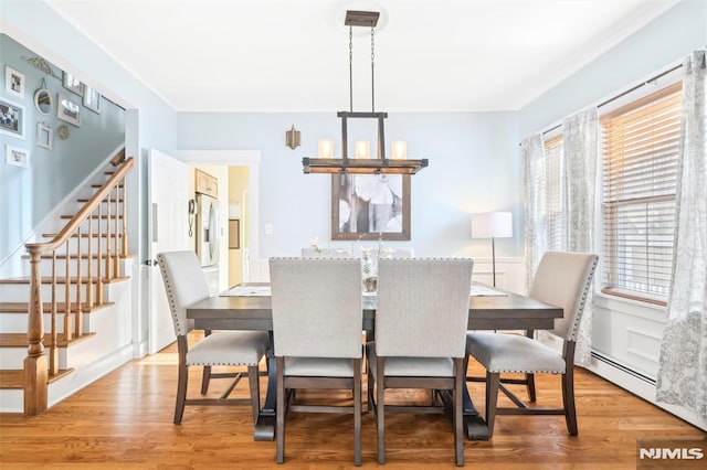 dining area featuring light hardwood / wood-style flooring and a chandelier