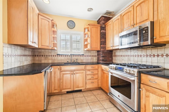 kitchen featuring light tile patterned floors, backsplash, stainless steel appliances, and sink