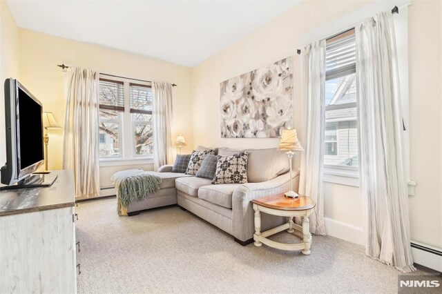 sitting room with carpet and a baseboard heating unit