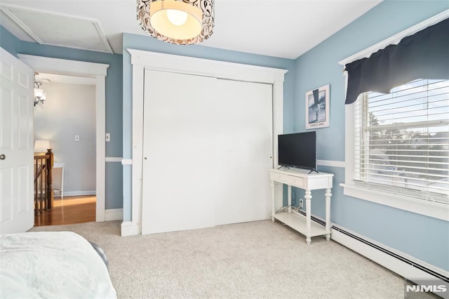 bedroom with carpet and a baseboard heating unit