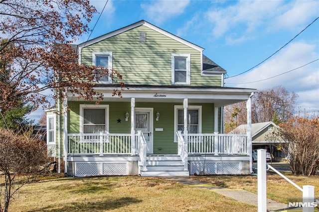 view of front of property with covered porch and a front lawn