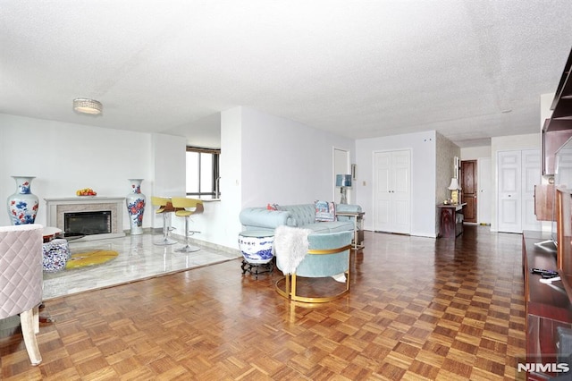 living room with parquet floors and a textured ceiling