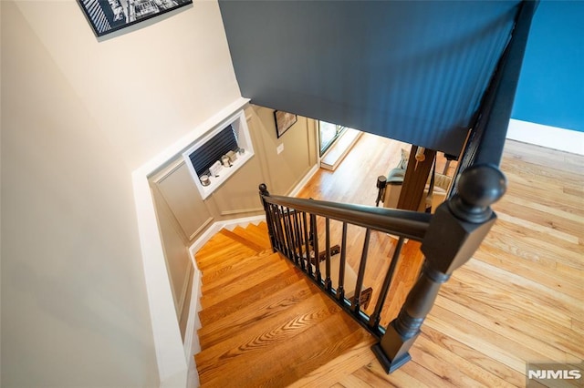 stairway with hardwood / wood-style floors