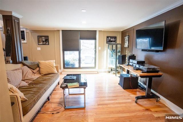 living room featuring crown molding and light hardwood / wood-style floors