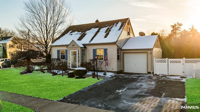 view of front facade with a garage and a lawn