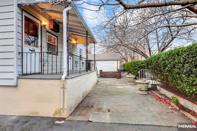 view of side of home featuring a patio area