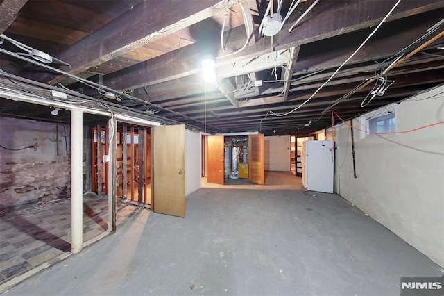 basement with white fridge