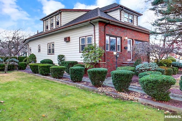 view of side of home with a yard