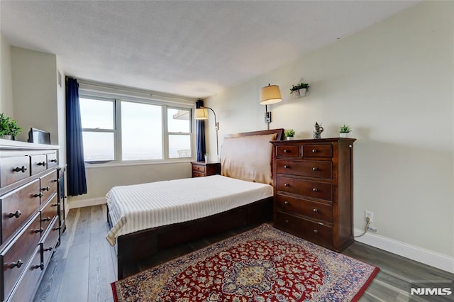 bedroom featuring dark wood-type flooring