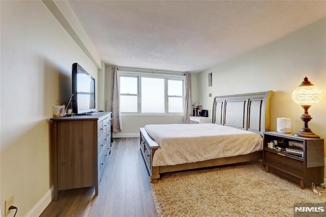 bedroom with wood-type flooring