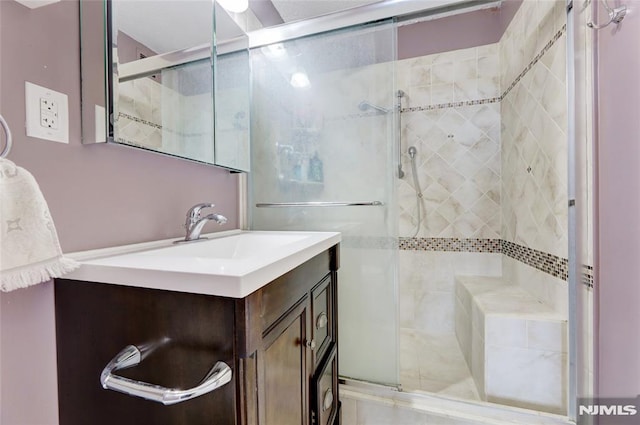 bathroom with vanity and an enclosed shower