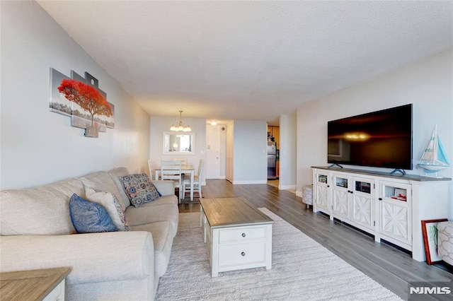 living room featuring hardwood / wood-style flooring and a notable chandelier