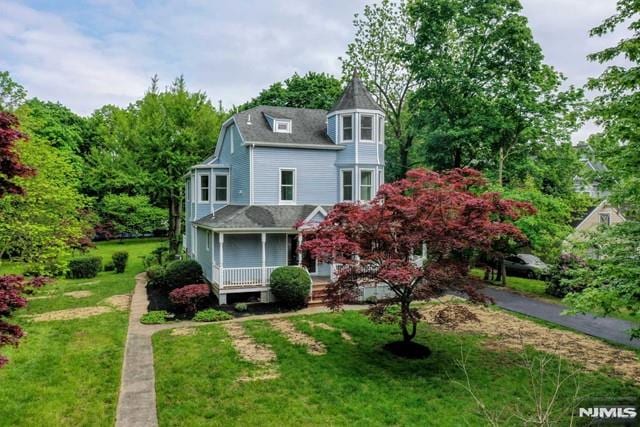 victorian house with covered porch and a front yard