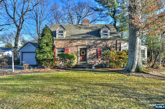 new england style home with a front yard and a garage