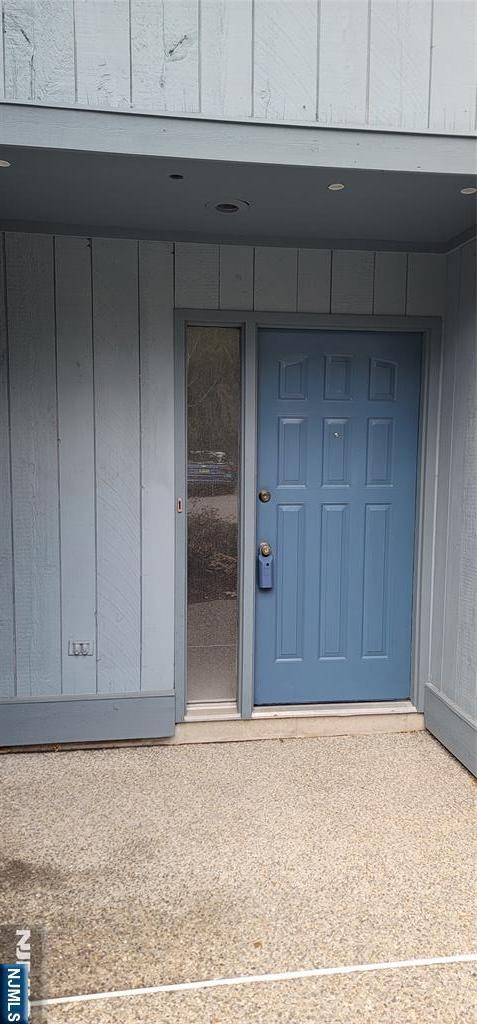 view of exterior entry with board and batten siding