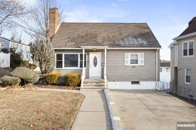 bungalow-style home with a front lawn