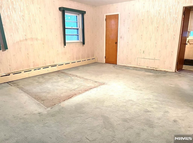 unfurnished room with concrete flooring and baseboard heating