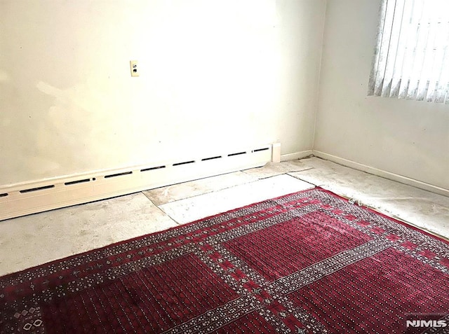 spare room with a baseboard heating unit