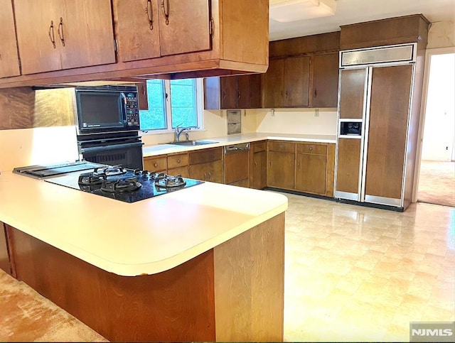 kitchen featuring kitchen peninsula, sink, and black appliances