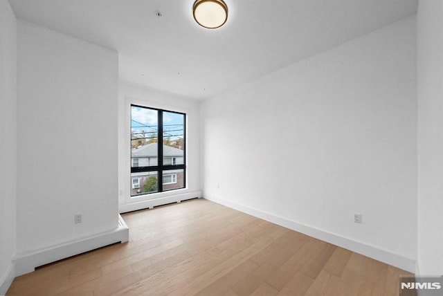 unfurnished room with light hardwood / wood-style floors