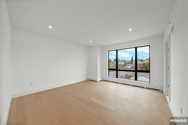 unfurnished room featuring light wood-type flooring