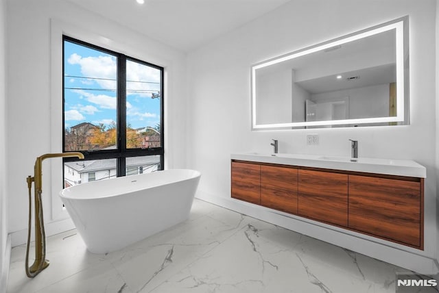 bathroom with vanity and a tub to relax in