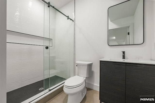 bathroom featuring vanity, an enclosed shower, and toilet