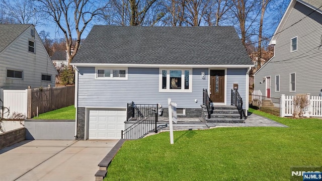 bungalow featuring a garage and a front lawn