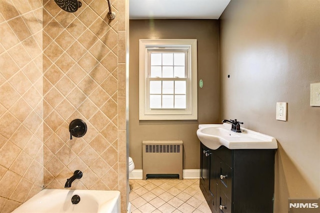 full bathroom with vanity, tiled shower / bath combo, tile patterned flooring, radiator heating unit, and toilet