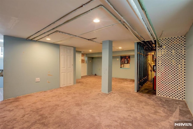 basement featuring light colored carpet