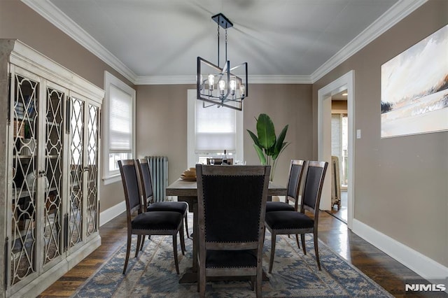 dining space with dark hardwood / wood-style flooring, ornamental molding, and a notable chandelier