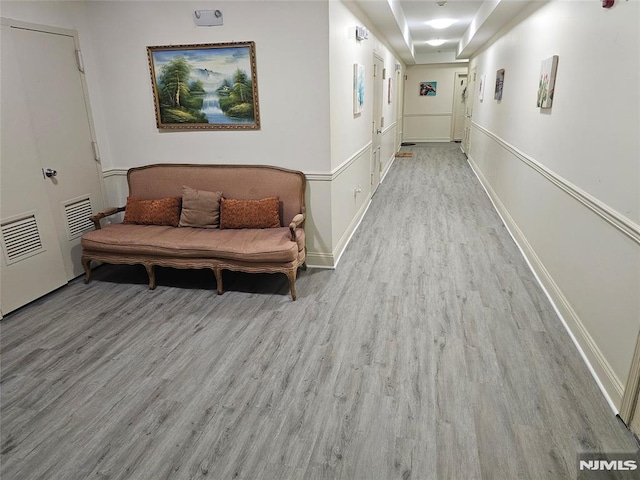 corridor with light hardwood / wood-style flooring