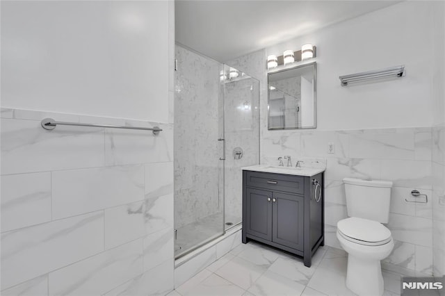 bathroom featuring vanity, an enclosed shower, tile walls, and toilet