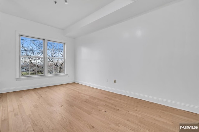 unfurnished room with light wood-type flooring