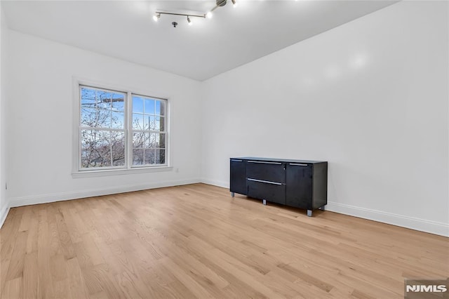 empty room with light hardwood / wood-style flooring