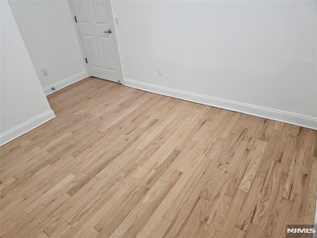 unfurnished room with light wood-type flooring