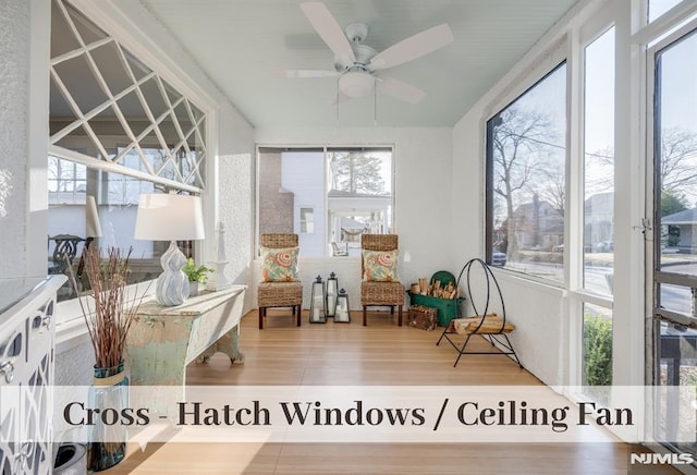 sunroom / solarium featuring ceiling fan