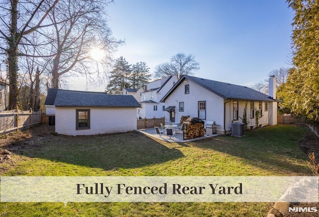 back of house featuring a yard, a patio, and central air condition unit