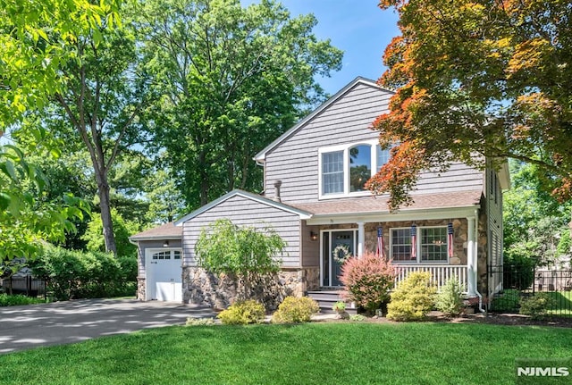 view of front property with a garage and a front lawn