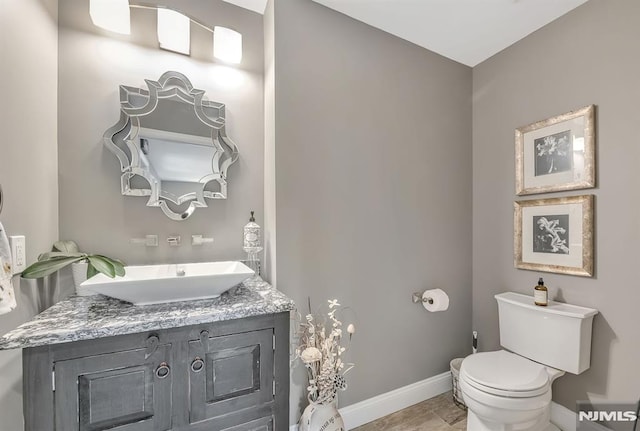 bathroom featuring toilet and vanity