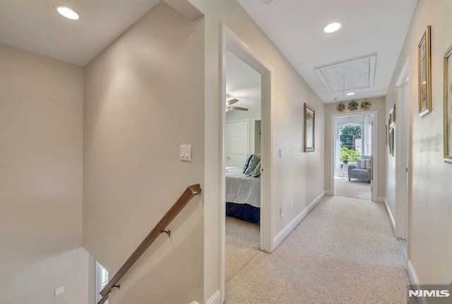 hallway featuring light colored carpet