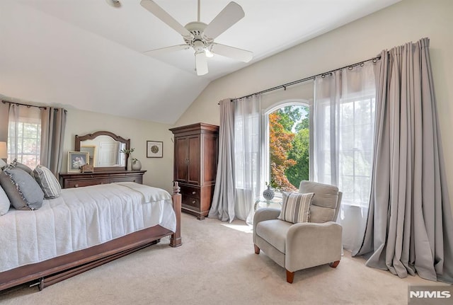 bedroom with ceiling fan, lofted ceiling, and light carpet