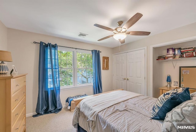 carpeted bedroom with ceiling fan and a closet