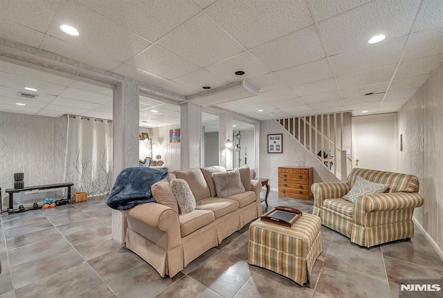 living room featuring a drop ceiling