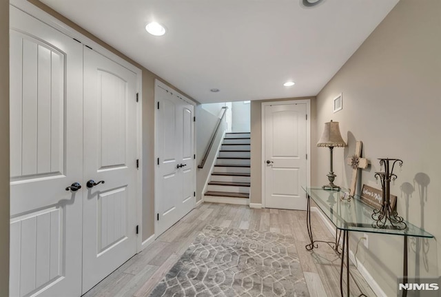 hallway with light hardwood / wood-style floors