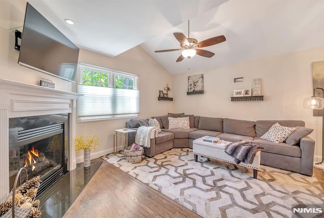 living room featuring ceiling fan, lofted ceiling, and wood-type flooring