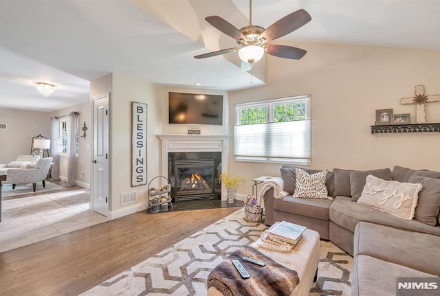 living room featuring ceiling fan and light hardwood / wood-style flooring