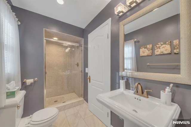 bathroom with toilet, sink, a shower with door, and tile patterned flooring